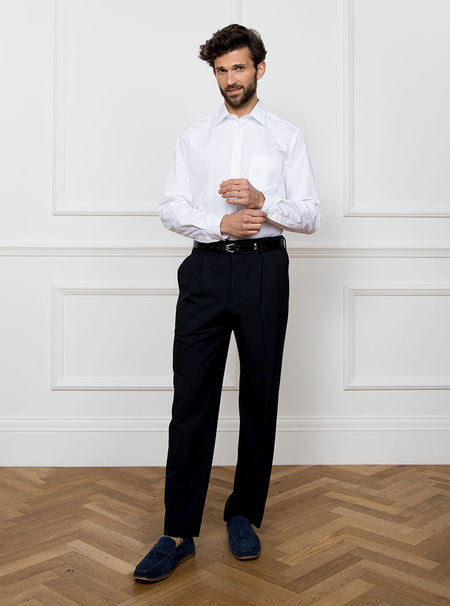 Man wearing white long sleeved shirt made with 100% Royal Oxford Cotton.
